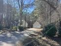 View of a home with a long driveway leading to a two-car garage and ample parking at 90 Wembley Ct, Youngsville, NC 27596