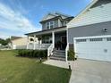 Charming two-story home featuring a cozy front porch and a two-car garage at 94 Aylebury Rdg, Zebulon, NC 27597