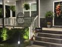 Well-lit front porch with comfy chairs, hanging plants, and a charming 'Blessed' sign at 94 Aylebury Rdg, Zebulon, NC 27597