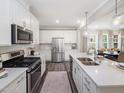 Modern kitchen with white cabinets, stainless steel appliances, and a large island at 1008 Sora Way, Durham, NC 27703