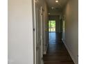 Hallway with wood floors leading to a room with sliding glass doors to a deck at 108 Grove Township Way, Angier, NC 27501