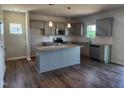 Kitchen with stainless steel appliances, granite countertops, and kitchen island at 108 Grove Township Way, Angier, NC 27501