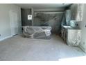 Unfinished kitchen with new appliances, including a wrapped island, promising a modern culinary space at 108 Grove Township Way, Angier, NC 27501