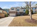 Lovely two-story home with a brick and siding exterior, attached two-car garage, and well-manicured lawn at 1137 Fanning Dr, Wake Forest, NC 27587
