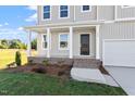 Front porch with white columns and a brick base offers a welcoming entrance to the home at 119 Grove Township Way, Angier, NC 27501