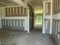 Spacious room featuring primed walls, ceilings, and visible framing elements at 119 Grove Township Way, Angier, NC 27501