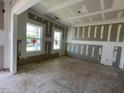 Bright room featuring primed walls, ceilings, framing elements and large windows at 119 Grove Township Way, Angier, NC 27501