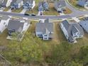 Aerial view of a single-Gathering home with fenced-in yard in a neighborhood with mature trees and landscaping at 130 Silent Brook Trl, Franklinton, NC 27525