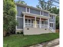 Charming two-story home boasts a covered front porch and fresh landscaping, offering great curb appeal at 1521 Chapel Hill Rd, Durham, NC 27701
