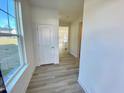 Bright entryway featuring wood-look flooring, fresh white trim, and a view into the kitchen at 169 Steel Springs Lane Rd # 17, Angier, NC 27501