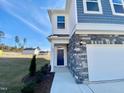 Stylish home showcasing a covered entryway, stone accents, and a manicured lawn at 169 Steel Springs Lane Rd # 17, Angier, NC 27501