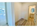 Hallway with wood-look flooring, leading to the powder room, and a view to the living area at 169 Steel Springs Lane Rd # 17, Angier, NC 27501