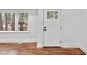 Bright entryway with a white door, hardwood floors, and window views at 1804 Beverly Rd, Rocky Mount, NC 27801