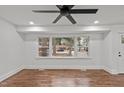 Bright living room with hardwood floors, a ceiling fan, and a large window overlooking the neighborhood at 1804 Beverly Rd, Rocky Mount, NC 27801