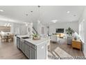 Open-concept kitchen and living area with a large island and hardwood floors at 185 Horseshoe Pl # 54, Angier, NC 27501