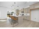 Bright kitchen with a marble countertop island, pendant lighting, and modern appliances at 185 Horseshoe Pl # 54, Angier, NC 27501