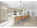 Open kitchen featuring a spacious island with bar seating, modern light fixtures, and ample cabinetry at 185 Horseshoe Pl # 54, Angier, NC 27501