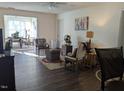 Inviting living room with natural light and open access to the dining area, with ceiling fan at 1911 Wolftech Ln # 303, Raleigh, NC 27603