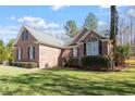 Brick house exterior with manicured shrubs, bright green grass, and architectural details at 2030 Lonesome Dove Dr, Franklinton, NC 27525
