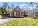 Well-maintained brick home with green lawn, mature trees, and ample curb appeal at 2030 Lonesome Dove Dr, Franklinton, NC 27525