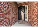 Close-up of brick facade and modern front door with decorative glass and welcome mat at 2030 Lonesome Dove Dr, Franklinton, NC 27525