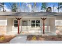 Inviting front porch with decorative window boxes and stylish wood columns offers a charming welcome at 210 S General Lee Ave, Dunn, NC 28334
