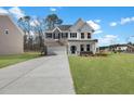 Inviting home exterior with brick and white siding, highlighted by blue shutters and a lush green lawn at 2156 Pink Peony Cir # 157, Durham, NC 27703