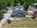 An aerial view highlighting the home, its spacious backyard, and the neighboring properties at 221 Charlotte Ave, Sanford, NC 27330