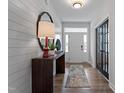 Stylish entryway featuring shiplap walls, a wooden console table, and modern decor at 232 Augusta Pond Way # 124, Raleigh, NC 27603