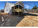 Exterior view of a two story home showing a wooden deck and spacious backyard at 2328 Eagle Shot Ct # 18, Fuquay Varina, NC 27526