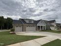 Charming home with a three car garage and gray and brick exterior at 2328 Eagle Shot Ct # 18, Fuquay Varina, NC 27526