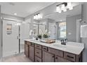 Modern bathroom featuring a double vanity, granite countertops, a glass shower, and bright lighting at 240 Augusta Pond Way # 122, Raleigh, NC 27603