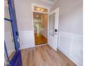 The foyer features wood floors and a view of the staircase and spacious living area at 394 Duncan Creek Rd # 158, Lillington, NC 27546
