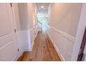 Hallway with wainscotting leads to the staircase and living area at 394 Duncan Creek Rd # 158, Lillington, NC 27546