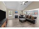 Cozy living room with a fireplace, vaulted ceilings, and plenty of natural light at 405 Joseph Alexander Dr, Fuquay Varina, NC 27526