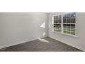 Light-filled bedroom with large window overlooking the yard and modern vinyl flooring at 413 Citron St, Sanford, NC 27332