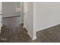 Hallway showing LVP floors, neutral walls, doors to rooms, and electrical outlets at 413 Citron St, Sanford, NC 27332