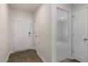 Inviting entryway showcasing hardwood flooring, a coat closet, and entry to a carpeted bedroom at 417 Citron St, Sanford, NC 27332