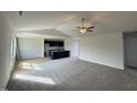 Open-concept living space with plush carpeting flowing into the kitchen area at 44 Harvest Hills Ln, Dunn, NC 28334