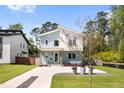 Stunning modern home featuring a stylish facade, manicured lawn, and inviting walkway at 505 Colleton Rd, Raleigh, NC 27610