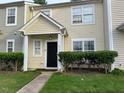 Inviting townhome with a well-manicured lawn and a clean, modern entrance at 5264 Patuxent Dr, Raleigh, NC 27616