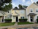 Charming townhomes featuring well-maintained landscaping and welcoming entrances at 5264 Patuxent Dr, Raleigh, NC 27616