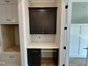 Desk nook includes dark wood cabinets, white countertop, and backsplash at 55 Cherry Bark Dr, Youngsville, NC 27596