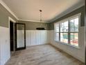Dining room featuring large windows for natural light, and stylish wainscoting that adds a touch of elegance at 55 Cherry Bark Dr, Youngsville, NC 27596