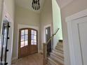 Bright foyer featuring high ceilings, hardwood floors, statement lighting, and an elegant wooden double door entry at 55 Cherry Bark Dr, Youngsville, NC 27596