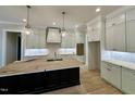Bright kitchen featuring gray cabinets, light countertops, an island, and elegant pendant lighting at 55 Cherry Bark Dr, Youngsville, NC 27596
