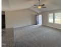 Living room with grey carpet, neutral walls, and natural light from two windows at 73 Phil Jack Rd, Dunn, NC 28334