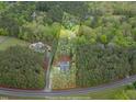 Aerial view of a home nestled amongst trees with an expansive lot outlined in yellow at 749 Bowden Rd, Chapel Hill, NC 27516