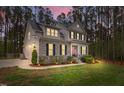 Stunning two-story home with stone accents, black shutters, manicured lawn, and professional landscaping at 749 Bowden Rd, Chapel Hill, NC 27516