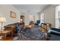 Cozy living room featuring hardwood floors, a decorative rug, and comfortable seating at 102 Trinity Dr, Elon, NC 27244